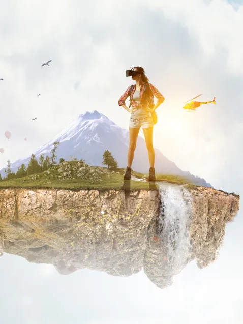 Traveler wearing VR goggles in mountain waterfall destination